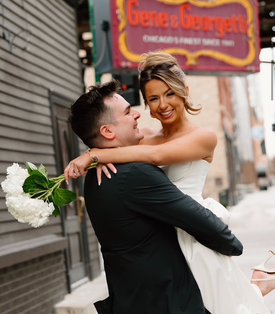 Newlyweds embracing outside Gene & Georgetti in Chicago